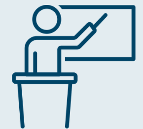 Icon of a person behind a podium teaching.
